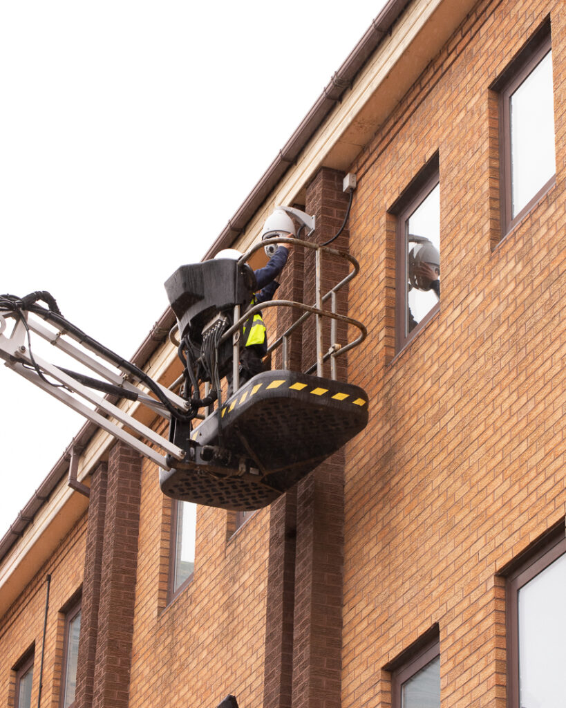 Engineer maintaining CCTV camera