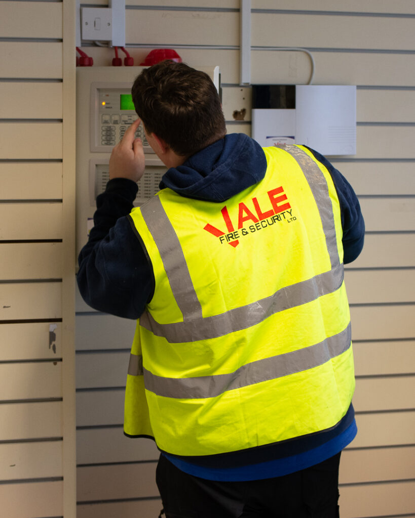 Engineer installing domestic intruder alarm
